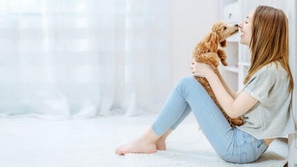 Girl holding small puppy