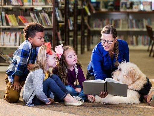 Teacher with kids and dog